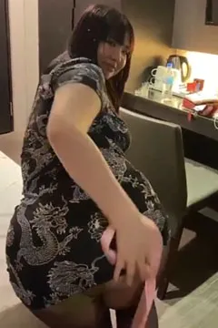 Dancing happily in a cheongsam and silk stockings
