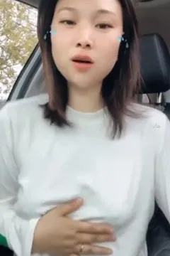 Beautiful woman kneading breasts in the car