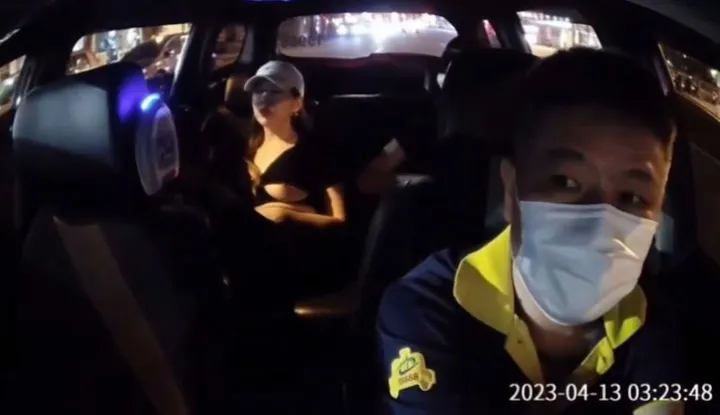 Drunk Taiwanese girl sits with exposed large breasts, taxi driver stares crazily.